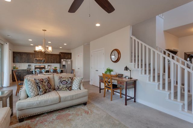 Great room with sofa, work desk and staircase at Ladera 370