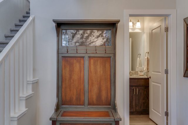 Entry hall with wooden bench cabinet and staircase at Ladera 370