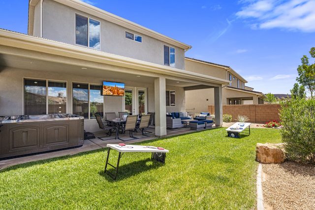 Rear of Ladera 379 with covered patio and grassy yard
