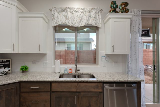 Kitchen sink under window with granite countertop at Ladera 415