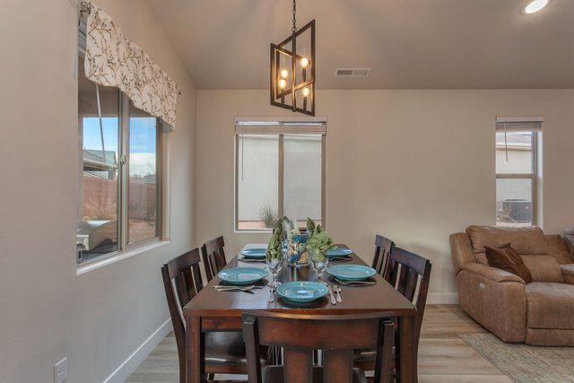 Dining table set for six with pendant light at Ladera 415