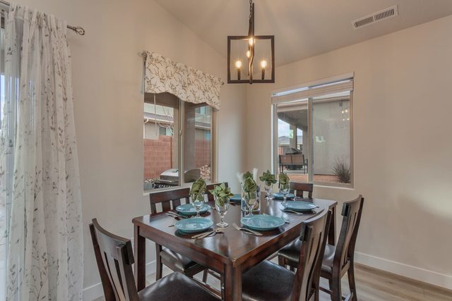 Dining area with table for six by windows at Ladera 415