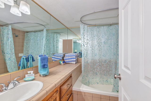 Bathroom vanity with mirror and tub-shower combination