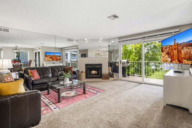 Living room with leather sofas, fireplace and balcony doors at Las Palmas 1507