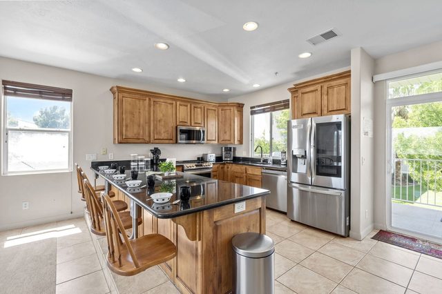 Kitchen island with granite counters and stainless steel appliances