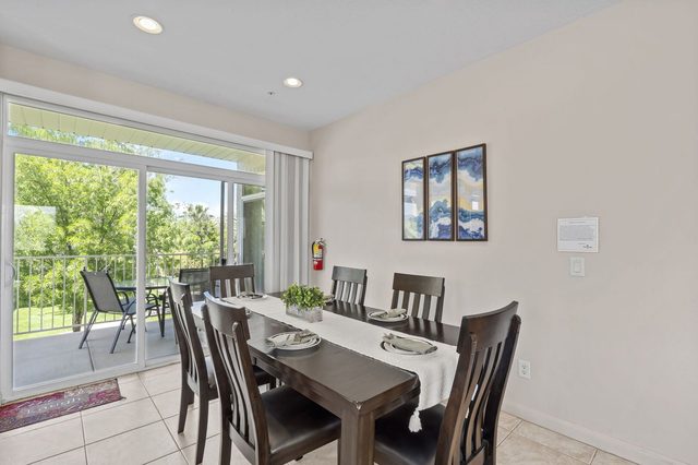 Dining table for eight beside sliding doors to the balcony