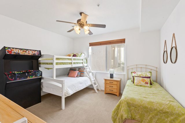 Bunk room with twin over full bunk, twin bed and arcade