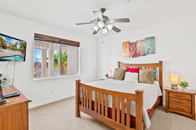 Queen bedroom with wood bed frame at Las Palmas 1806