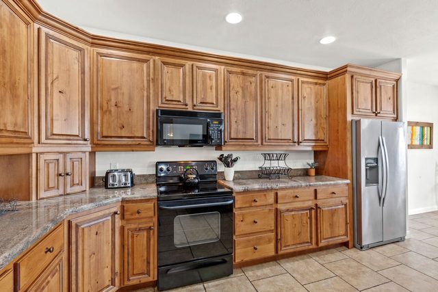 Kitchen range, microwave and stainless steel refrigerator