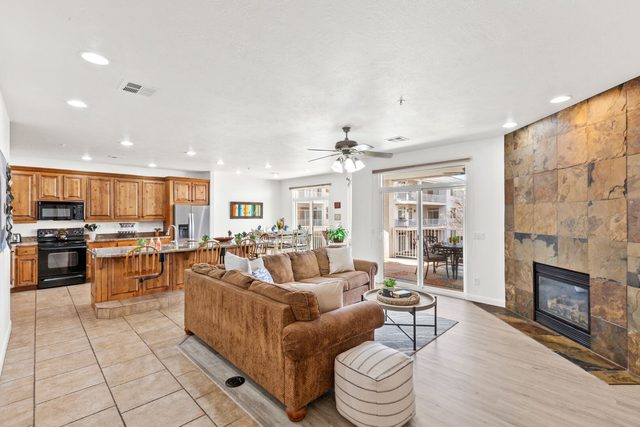 Open living room and kitchen with tile fireplace at Las Palmas 1806