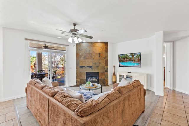 Living room sectional facing the tiled fireplace and TV