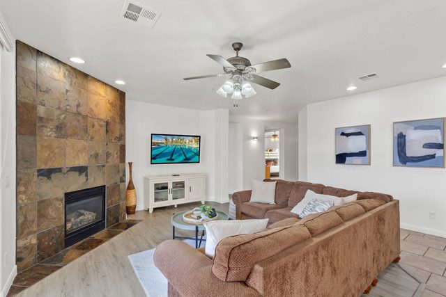 Living room with fireplace, sectional sofa and wall TV