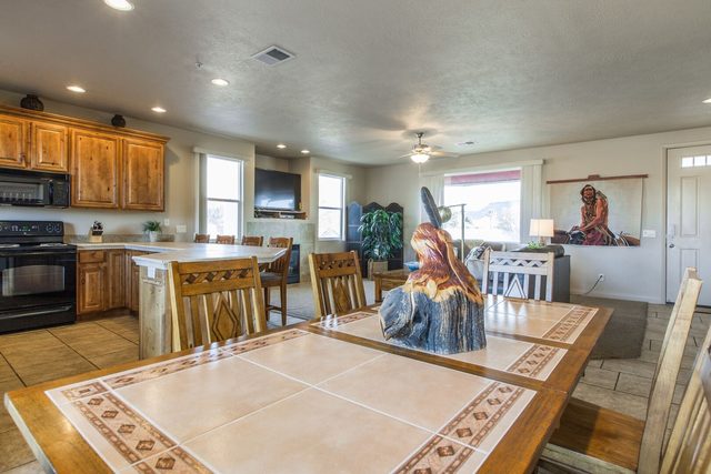 Dining table with kitchen and living area beyond
