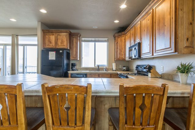 Kitchen breakfast bar with four wooden bar stools