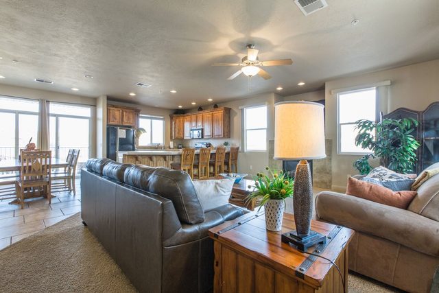 Open living room with leather sofas flowing into the kitchen