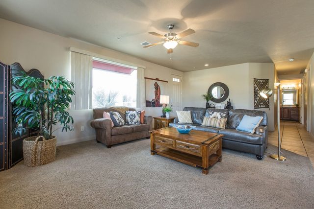 Living room seating with coffee table and hallway view