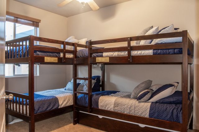 Bunk room with two sets of twin bunk beds and a trundle