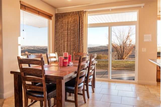 Dining table beside sliding doors with mountain views at Las Palmas 2102