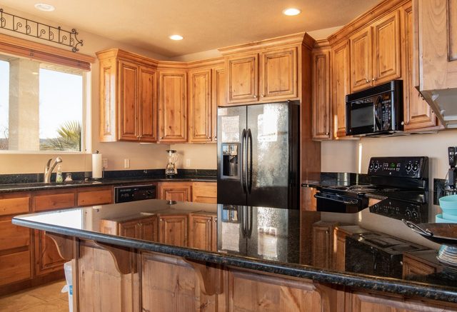 Kitchen island with granite counters and bar seating at Las Palmas 2102