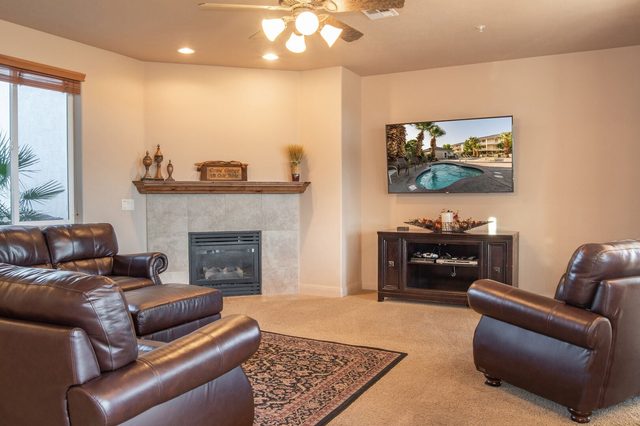 Leather seating around the fireplace and TV at Las Palmas 2102