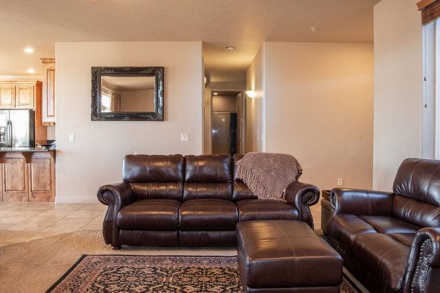 Great room leather sofa and ottoman beside the kitchen