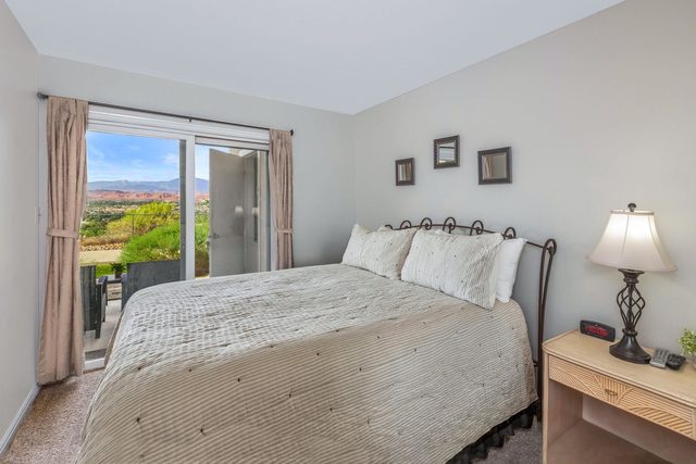 Queen bedroom with sliding door to patio and desert views