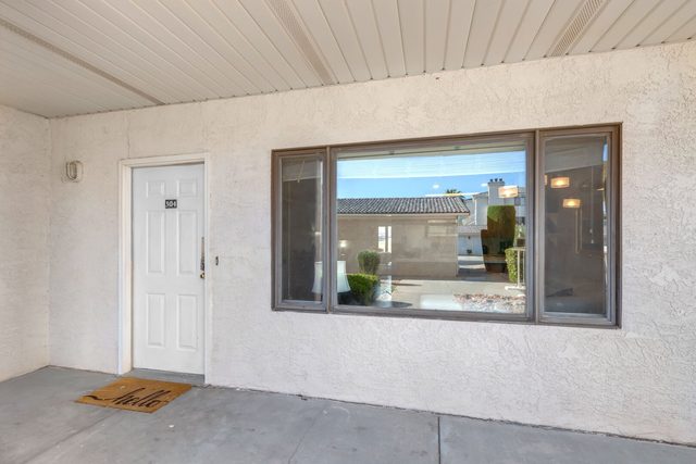 Front entry door and picture window of Las Palmas 304