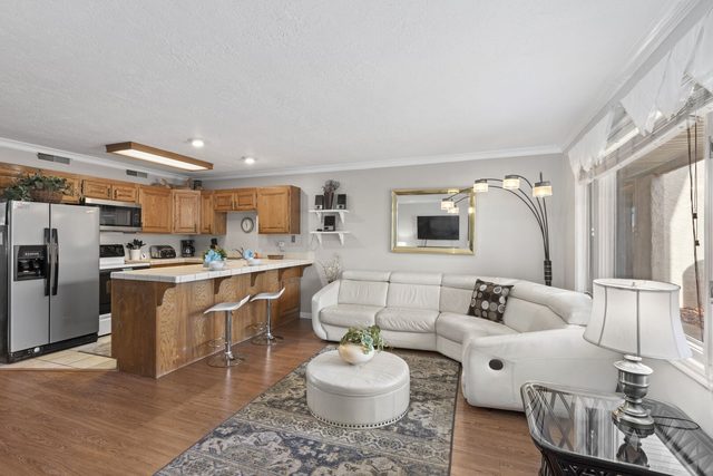 Open kitchen and living room with white sectional at Las Palmas 304