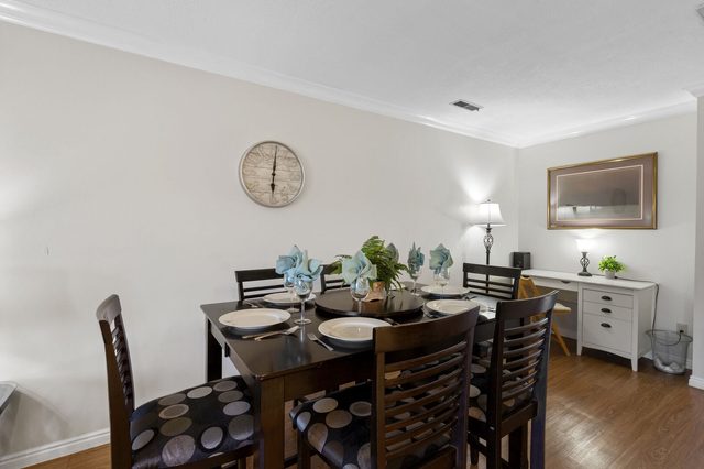Dining table for six beside a small work desk