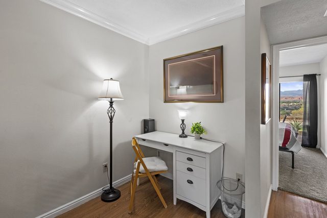 Designated workspace desk with lamp near the hallway
