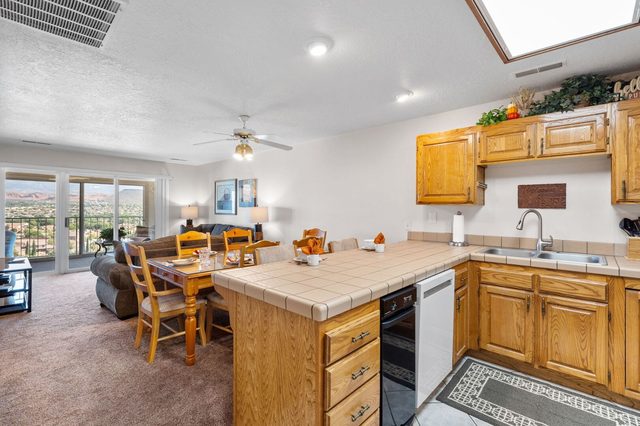 Open kitchen and dining area flowing to the living room and balcony