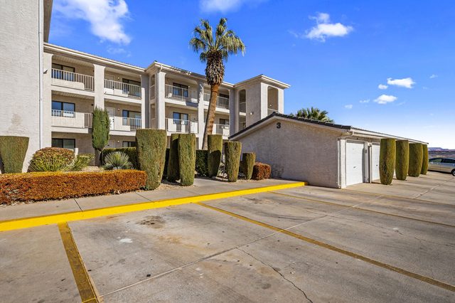 Las Palmas condo building and parking lot with palm trees