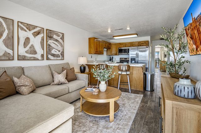 Living room with sectional and kitchen beyond at Las Palmas 328