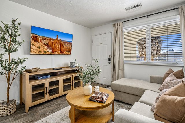 Living room with sectional sofa and wall-mounted smart TV