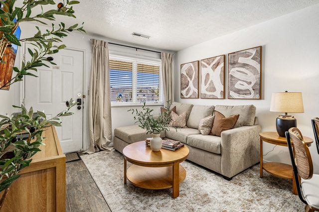 Living room sofa with round coffee table by the entry