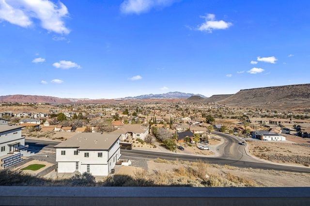 Balcony view over St. George neighborhoods toward distant mountains