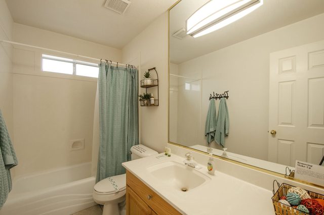 Bathroom with tub shower combo and single vanity