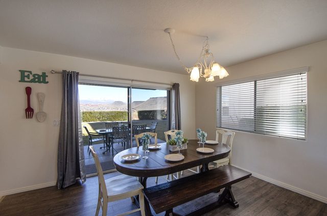 Dining table with bench beside sliding doors to the patio
