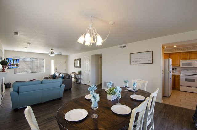 Round dining table open to the living room and kitchen