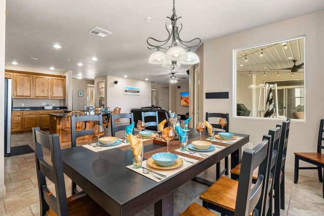 Dining table set for eight next to kitchen in condo 804