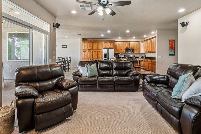 Open living room with leather sofas facing the kitchen in condo 804