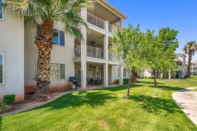 Three-story Las Palmas condo building with balconies and green lawn
