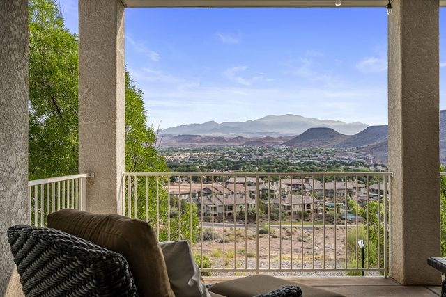 Balcony view over St. George toward desert mountains and red cliffs