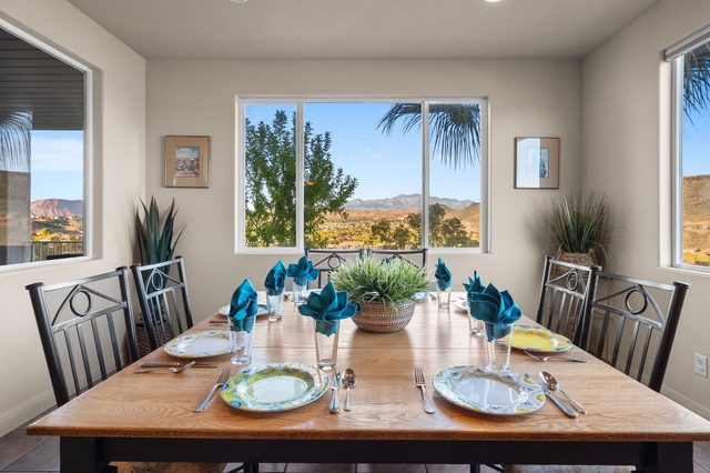 Set dining table with desert and tree views through the windows