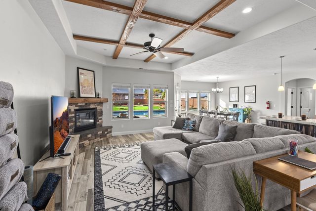 Great room with beamed ceiling, sectional sofa, fireplace and TV
