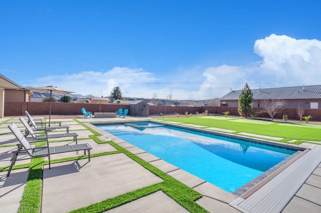 Private rectangular pool with lounge chairs at LaVerkin 112~Poolside Paradise
