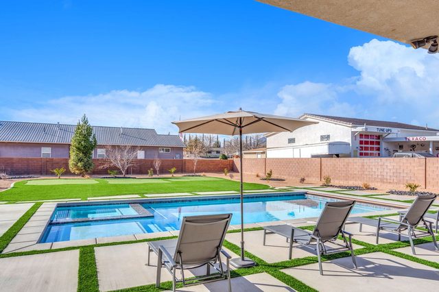Private pool and spa seen from the covered patio with umbrella