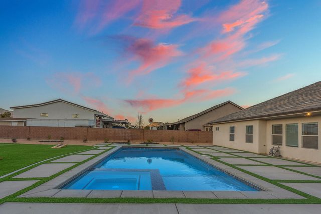 Private pool and attached spa beside the house at sunset