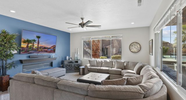 Home 107 living room with large sectional and wall TV
