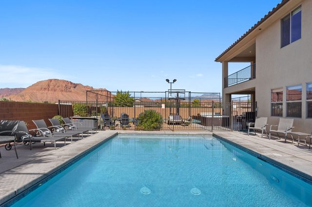 Home 108 private pool with loungers and red cliffs beyond